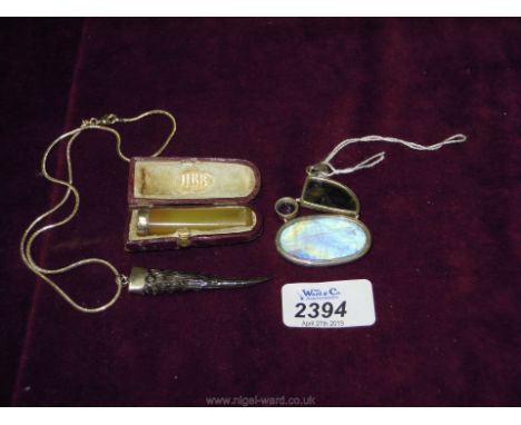 A token Pendant and later chain, a silver and amber cigarette holder and white metal framed abstract shape pendant set with a