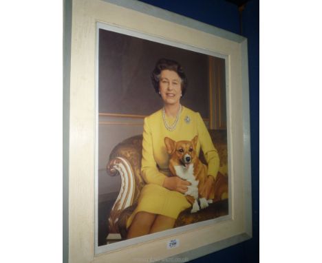 A framed and mounted Print of Her Royal Majesty Queen Elizabeth, sat with one of her Corgis.