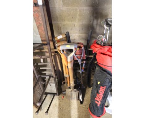 A quantity of garden tools to include digging fork, spades, garden shears and a shooting stick 