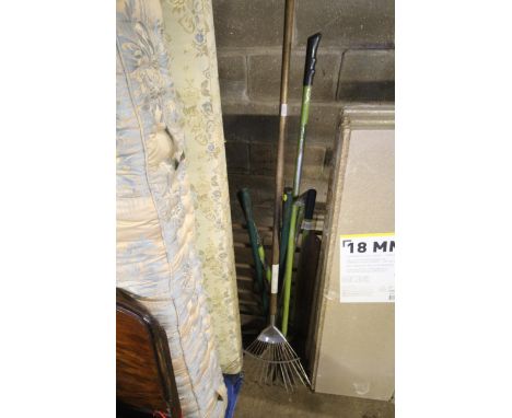 A quantity of long handled garden tools to include rake, garden shears etc. 