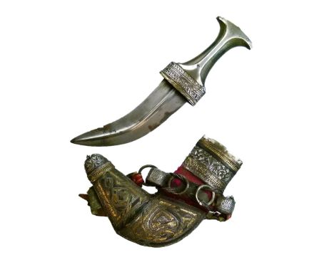 Omani Jambiya, 20th Century, the curved double edged blade with medial ridge and waisted dark horn hilt with white metal moun