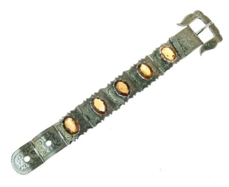 Victorian citrine set buckle bracelet, the five oval cuts set to engraved panels, unmarked, 18cm longest length   Condition: 