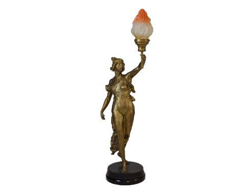 Early 20th Century French gilt spelter figural lamp, modelled as a maiden holding a torch aloft, on naturalistic circular bas