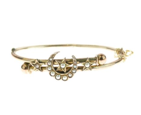 Edwardian seed pearl set hinged bangle, unmarked, with a crescent and stars frontispiece, internal diameter 5.6cm, 6.3g gross