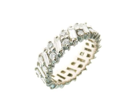 Diamond eternity ring, in unmarked white metal, alternate set with baguette cut and pairs of brilliant cuts, totalling approx
