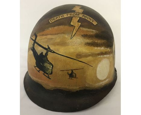 A Vietnam War era US MI helmet with post war 101st Airborne memorial hand painted detail.  Depicting the American flag, playi