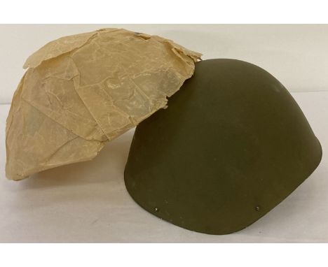 An M39 Greek Army helmet with original factory wrapping paper, in as new condition.  Stamped 'Ellinikos Stratos' to interior 
