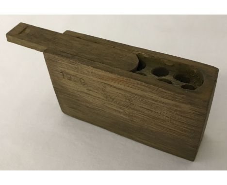 A WWII style German stick grenade wooden fuse box with sliding lid.   Approx. 5.5 x 9 x 2.5cm.