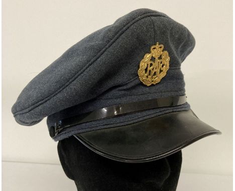 A 1962 RAF peaked cap with cap badge by J. Collett Ltd. With war arrow to inside rim.   Size 7 1/4.