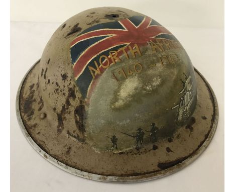 A WWII style British Brodie helmet with post war hand painted 8th Army memorial detail.  Depicting Union Jack flag, tanks and