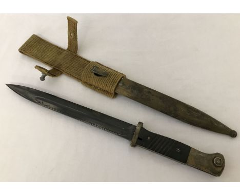 A German WWII Africa Corps K-98 bayonet with scabbard and frog.  The D.A.K. palm tree logo has been engraved on the pommel. 