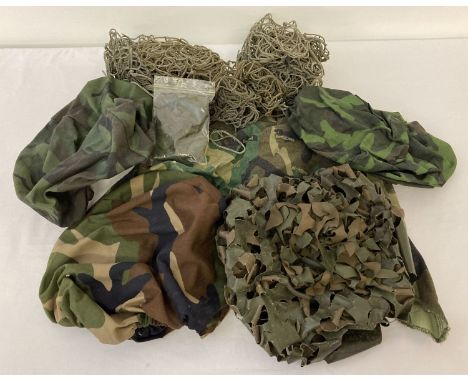 A quantity of assorted helmet nets, covers and scrim.  Comprising: 6 x Austrian helmet nets, a 1980's French Army helmet scri