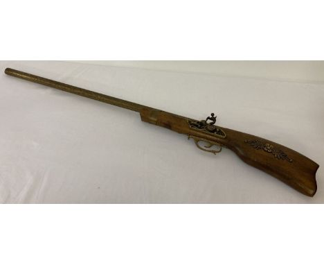 A reproduction ornamental rifle with decoration to handle and hanging ring to back.   Approx. 106 cm long.