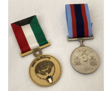 A 1991 Kuwait liberation medal together with a Pakistan Air Force medal. Both with ribbons.  