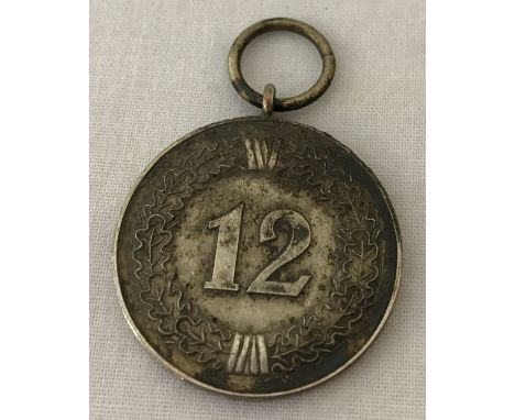 A WWII style German Army 12 year long service medal, no ribbon.   Approx. 3cm diameter.