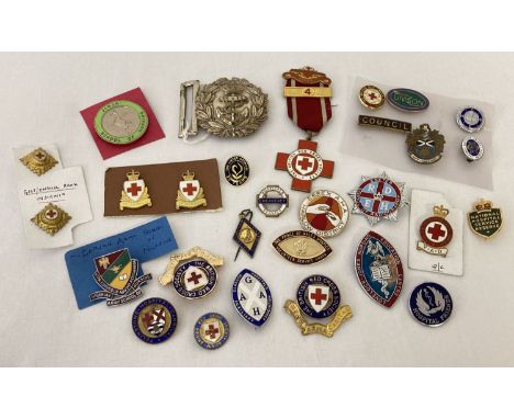 A collection of Red Cross badges and medal together with enamelled nursing badges.  To include Nigerian Army Nursing and Jinj