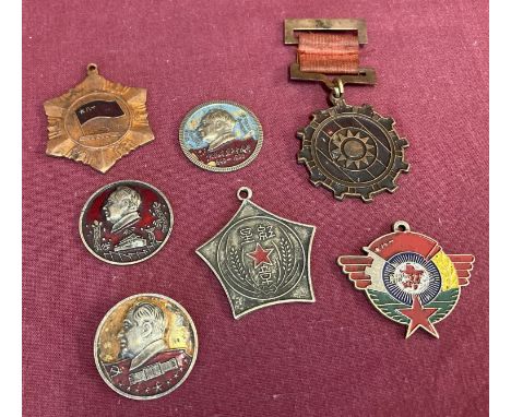 A collection of 7 vintage Chinese military medals and badges.  