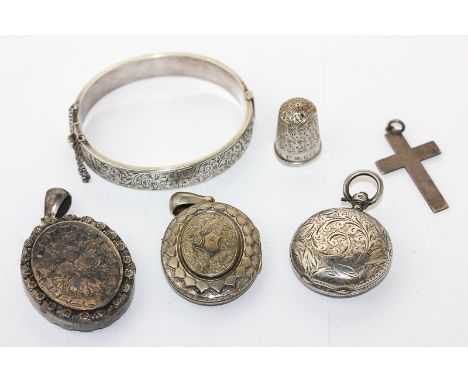 A silver bangle; sovereign case; two lockets; thimble and a cross