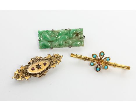 A carved and pierced jade brooch on silver; a turquoise and seed pearl bar brooch and a rose diamond and ruby brooch