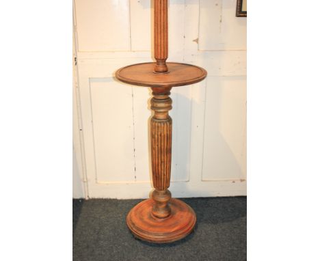 An early 20th century standard lamp with reeded baluster stem, circular shelf and base, 152cm