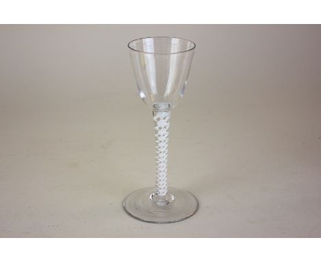 An 18th century cordial drinking glass, rounded funnel bowl, on opaque twist stem 15cm 