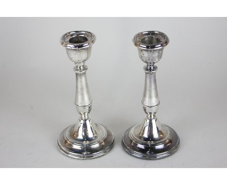 A pair of George V silver candlesticks, baluster shape, on loaded circular bases, maker W Hutton and Sons, Birmingham 1916, 1