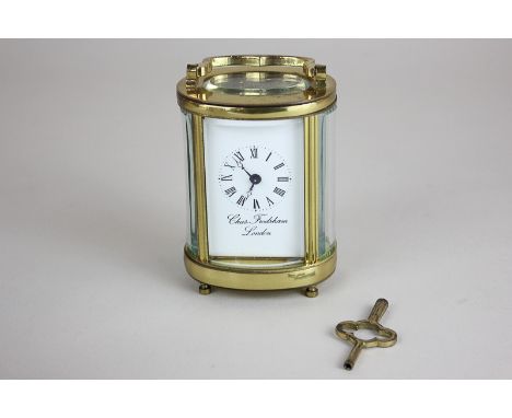 A 19th century Charles Frodsham brass and bevelled glass miniature oval carriage clock/boudoir clock with Roman numerals, the