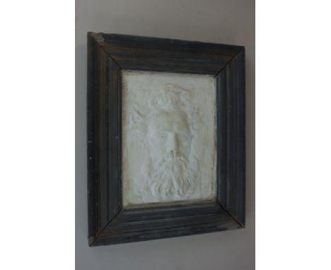 A plaster plaque of a portrait of William Morris, framed, 19cm by 14cm