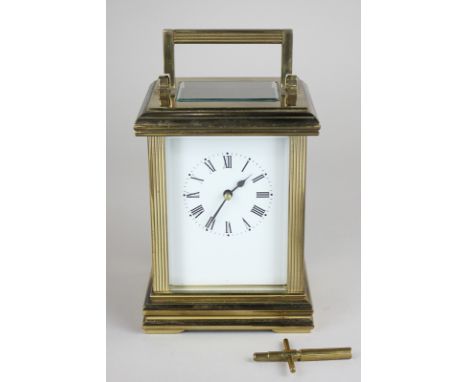 A brass and bevelled glass cased carriage clock, the white enamel face with Roman numerals, half striking on a bell, 17cm hig