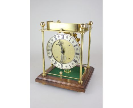 A 20th century Thwaites & Reed rolling ball table clock, the Swiss skeleton movement with silverised chapter ring and Roman n