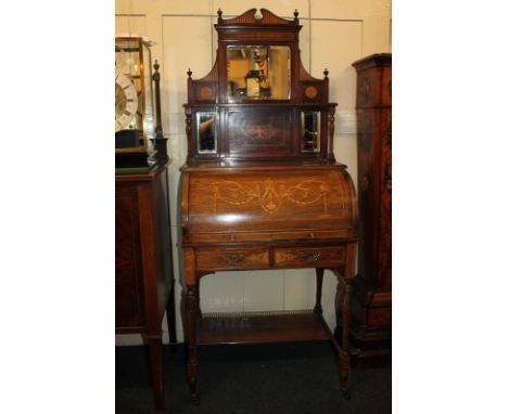 A late Victorian inlaid rosewood cylinder desk with raised mirror back and shelf, scroll decorated fall, fitted interior (a/f