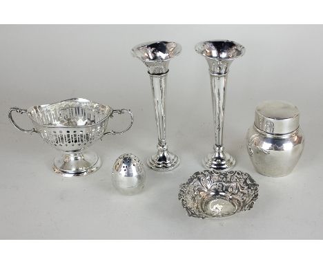 A pair of George V silver bud vases with circular loaded bases, 13cm high, (a/f), a tea caddy, a floral pierced dish, and an 