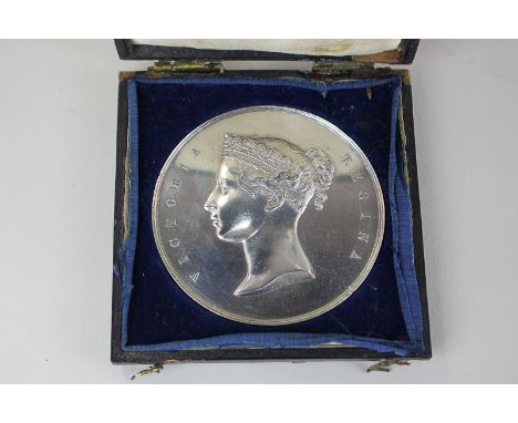 An East Indian Railway 1860 silver medal, the opening of the East India Railway to Rajmahal, one side with bust of Queen Vict