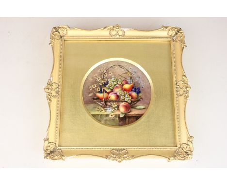 A Royal Worcester circular porcelain plaque painted with flowers and fruit in a basket by R Sebright, signed, 10.3cm diameter