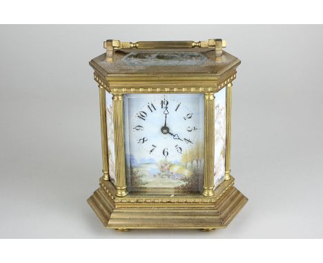 A French brass and bevelled glass cased carriage clock with hand painted porcelain panels depicting winged cherubs in a lands