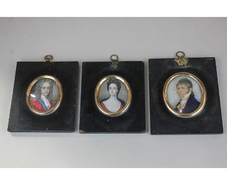 Three 19th century oval portrait miniatures on ivory, comprising a gentleman in a blue jacket with damaged paper label verso,