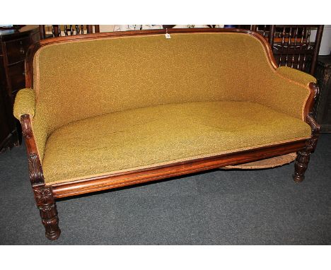 A William IV rosewood upholstered sofa, the shaped rectangular back leading to padded arms with foliate scroll carved fronts,