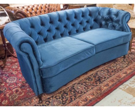 SOFA, in button back blue velvet with concave seat and cabriole supports, 195cm x 92cm x 94cm H. 