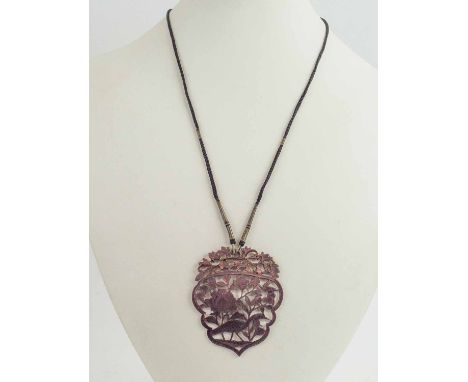 A FINE ANTIQUE CHINESE 18K GOLD AND MOTHER OF PEARL CARVED PENDANT, wearable both sides on a silk braide.