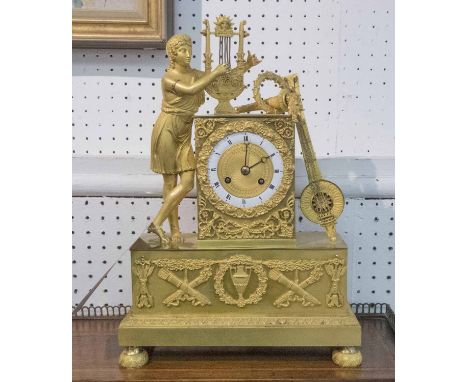 A FRENCH EMPIRE CLOCK, circa 1825, designed at a young man playing a lyre, 36cm H x 25cm W. (overall good condition)