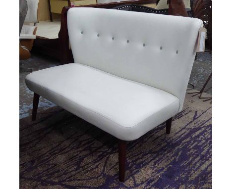 DESIGNERS GUILD SOFA, two seater, in cream leather button back on turned supports, 123cm L.