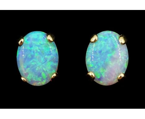 Pair of 14ct gold opal stud earringsCondition Report:Approx 1.55gm, length = 10mm, tested 14ct 