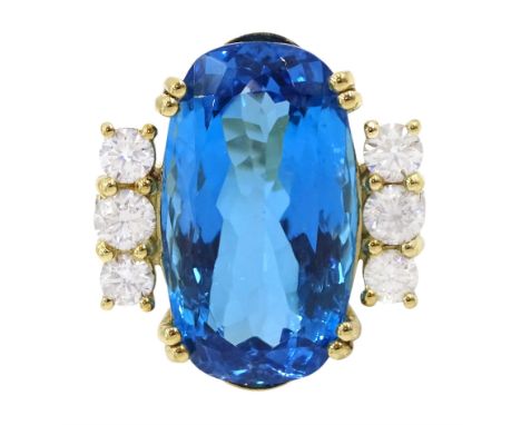 18ct gold oval blue topaz ring, with four round brilliant cut diamonds set either side, topaz approx 31.10 carat, total diamo