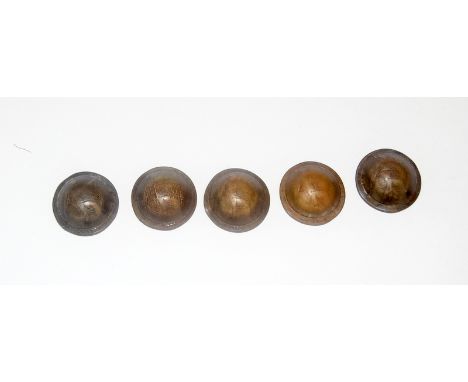 A set of five old pennies formed into WW1 trench art British Army helmets and dated from 1914 through to 1918