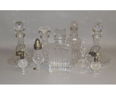 A collection of mixed crystal glass decanters, including a ship's decanter