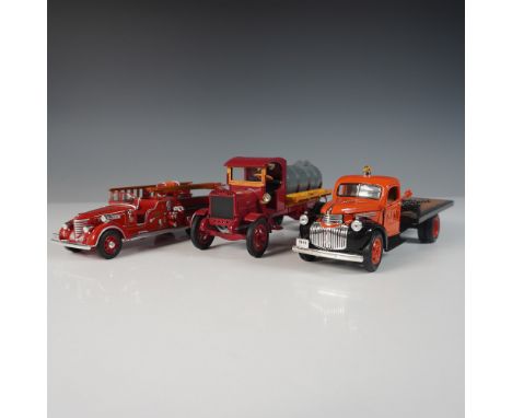 A collection of three vintage die-cast trucks featuring exceptional detail. Includes a 1939 Packard Fire Engine with chrome a