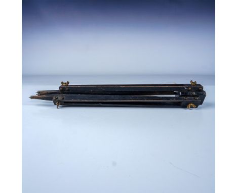 A vintage wooden tripod featuring adjustable legs and brass fittings, designed for durability and functionality. The tripod d