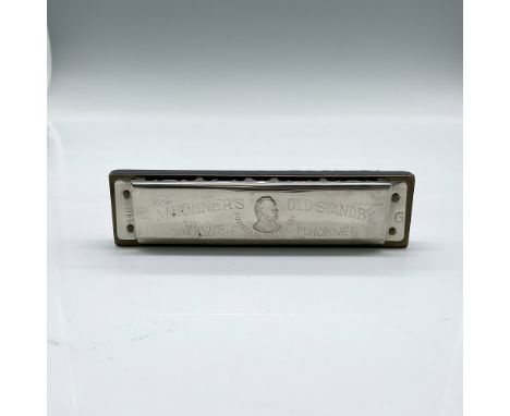 This model with 10 single holes and 20 reeds is set in brown and black stained wooden comb. Metal etched cover plates are att