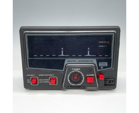 Vintage Tomy Digital Daredevil handheld electronic game. Features a detailed control panel with options for high and low-spee