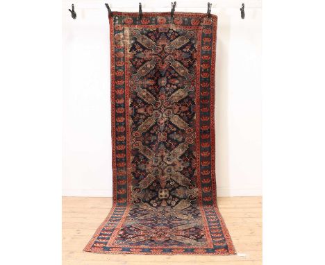 A Kuba runner,late 19th to early 20th century, of Zaykhour design, with four central medallions, to a navy ground, and red bo
